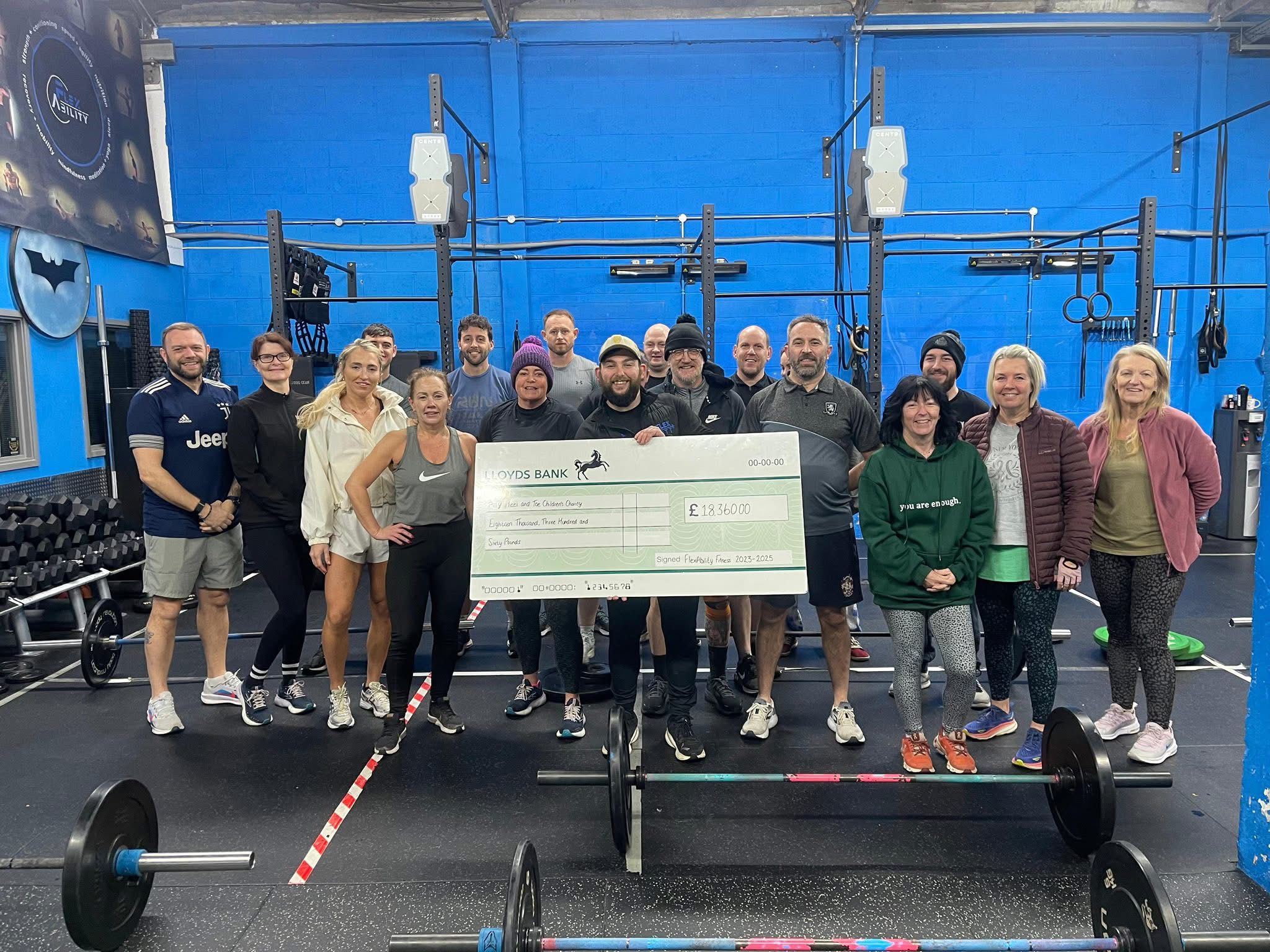 FlexAbility Fitness presenting £18,600 cheque to Heel & Toe Children's Charity